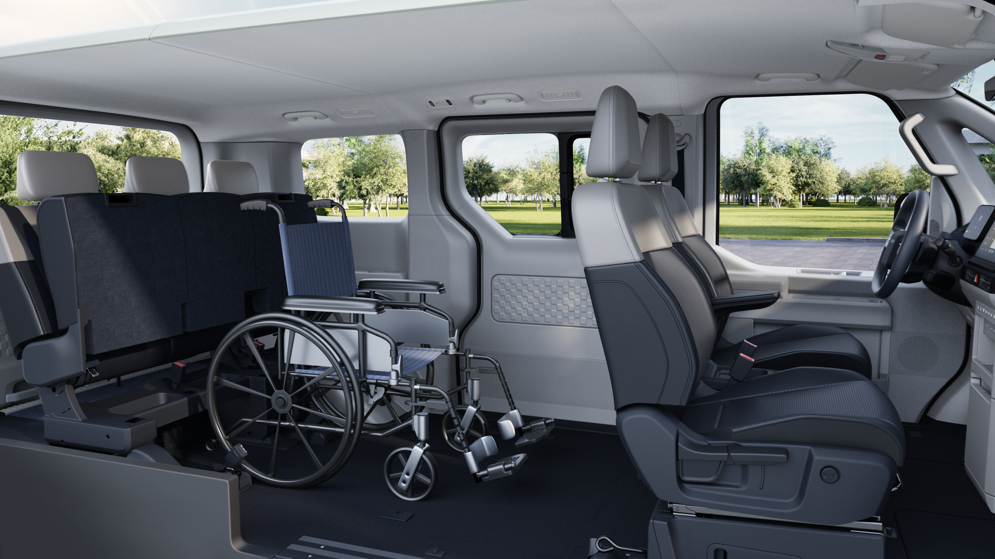 A photo of the inside of the Kia PV5 Wheelchair Accessible Vehicle. The back seats have been flipped back while a manual wheelchair sits in the middle.